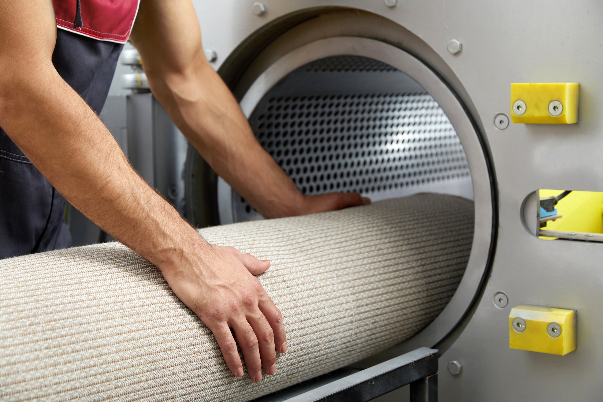 Man operating drying machine for carpet cleaning. Professional carpet cleaning service